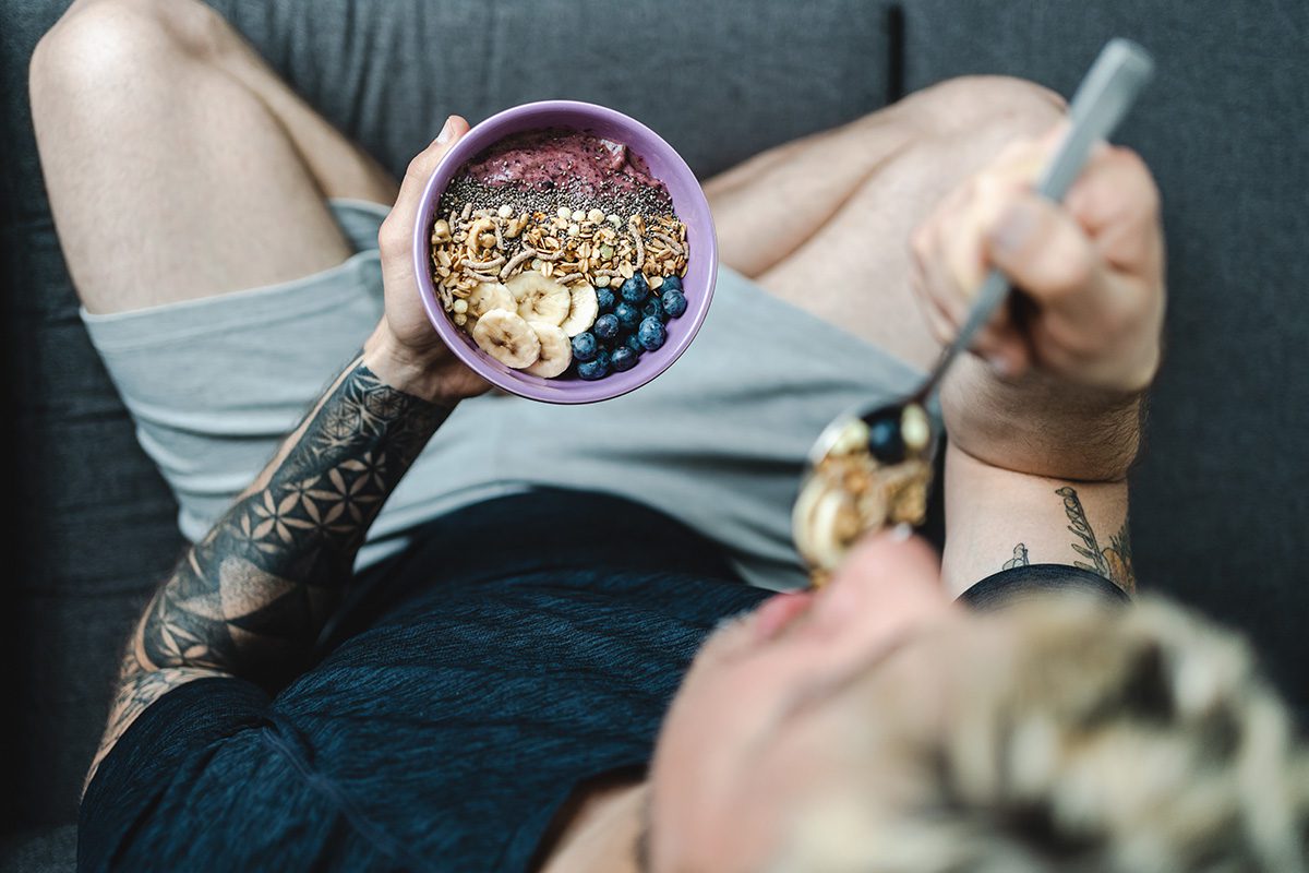 Man with tattoos eating breakfast