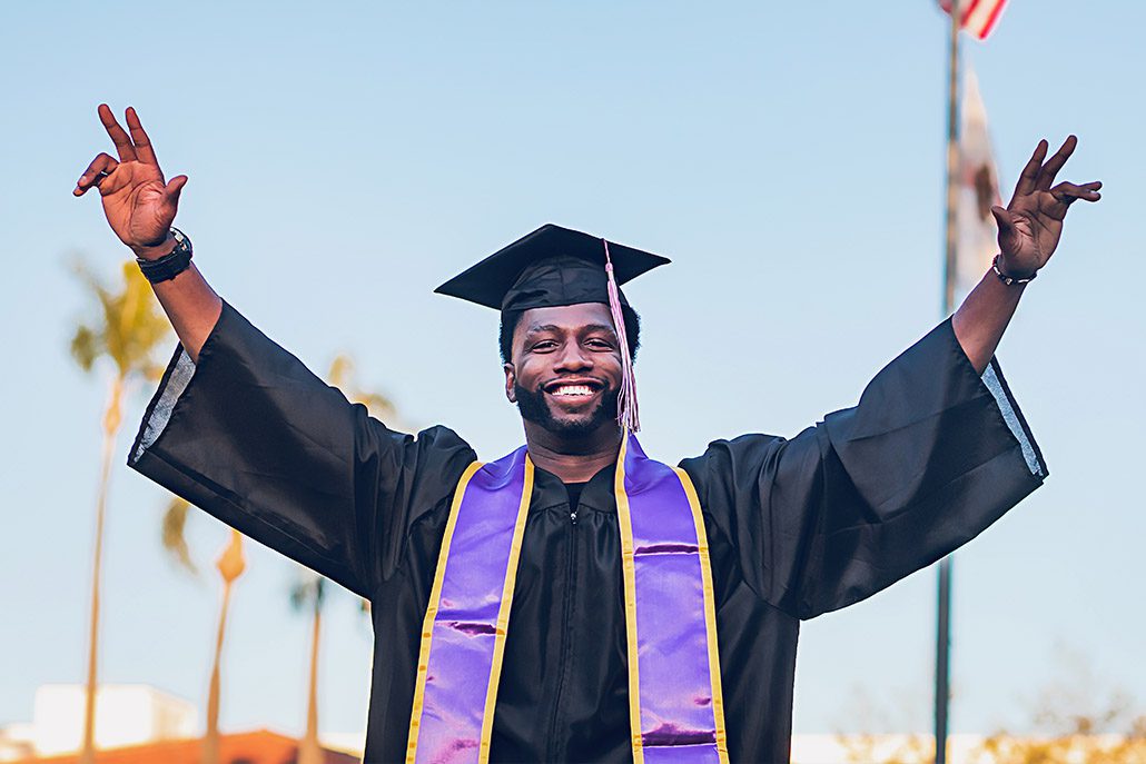Man celebrating in cap and gown
