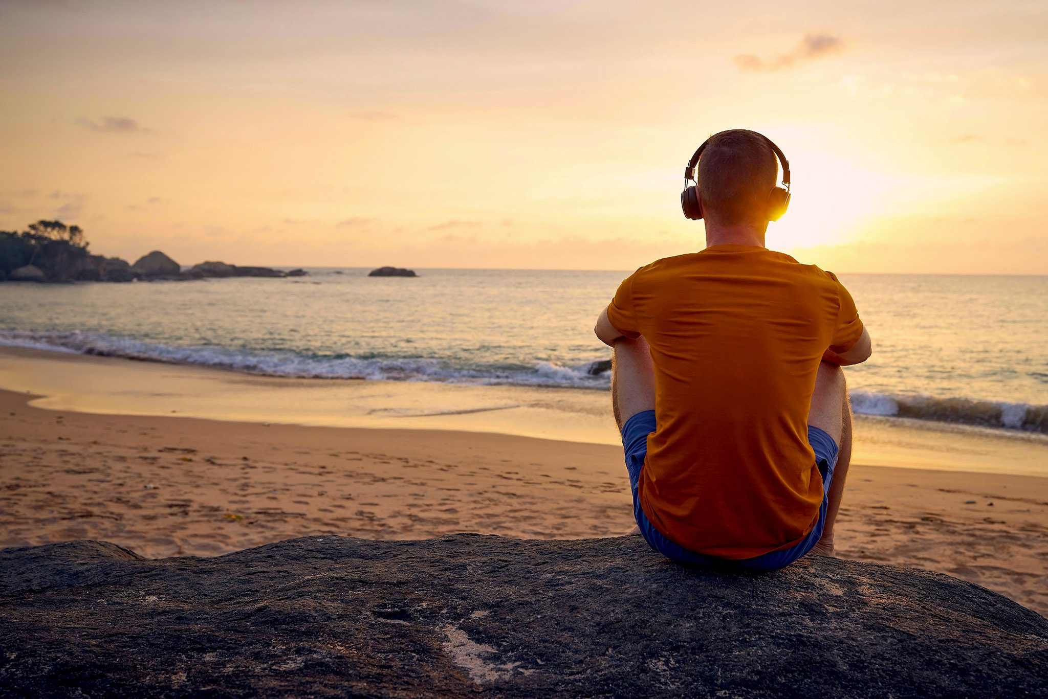 Man listening to music at beach